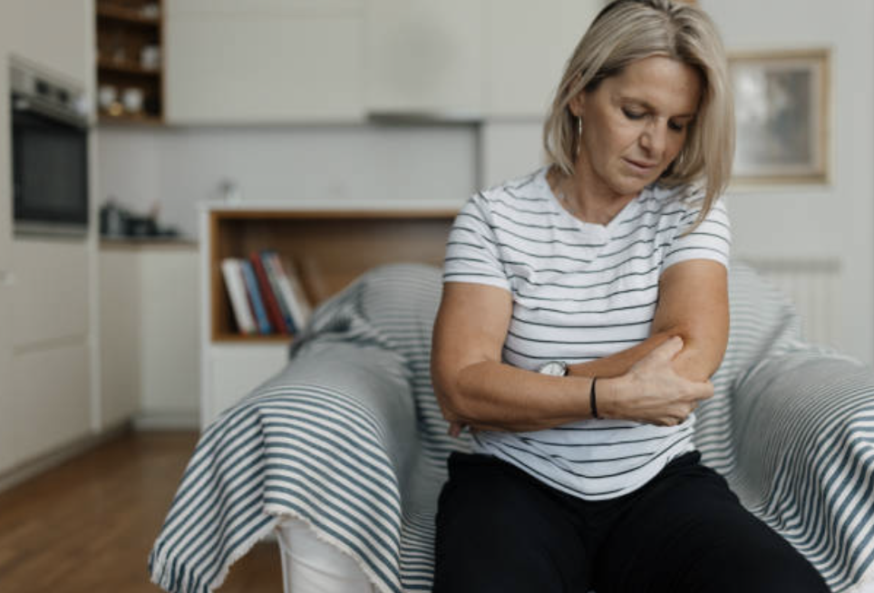 Woman with Elbow Pain at Home
